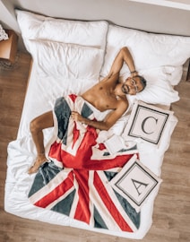 woman in red and white dress lying on bed