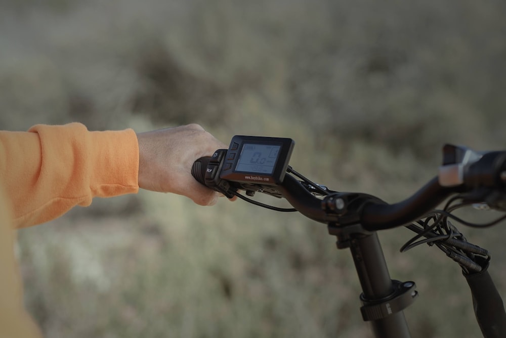 person holding black digital camera