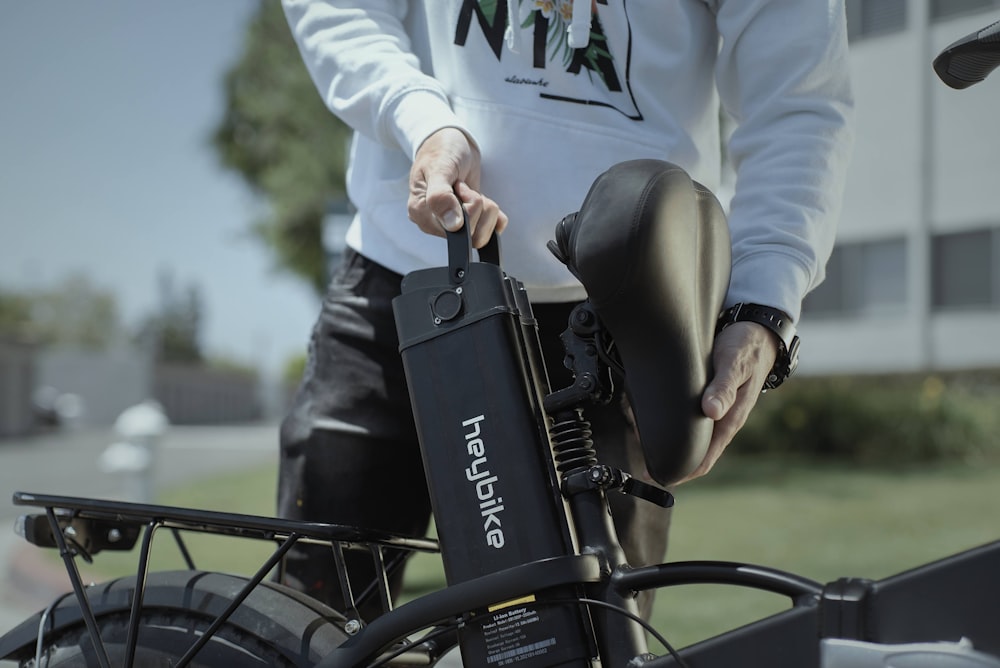 person in white long sleeve shirt riding bicycle during daytime