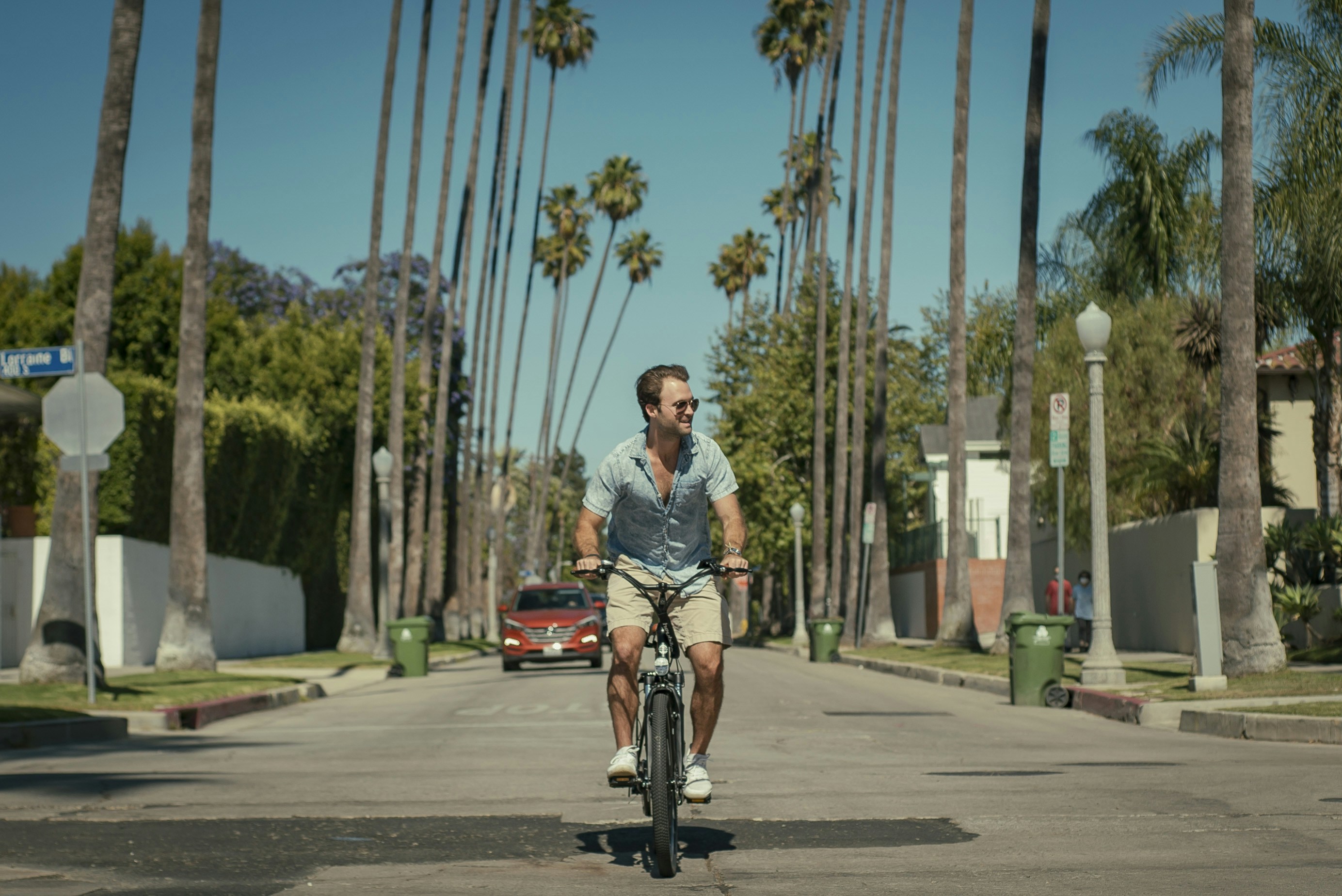 woman in gray shirt riding bicycle on road during daytime