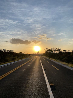 Sunset view of a completed road stretching into the horizon, symbolizing progress and quality.