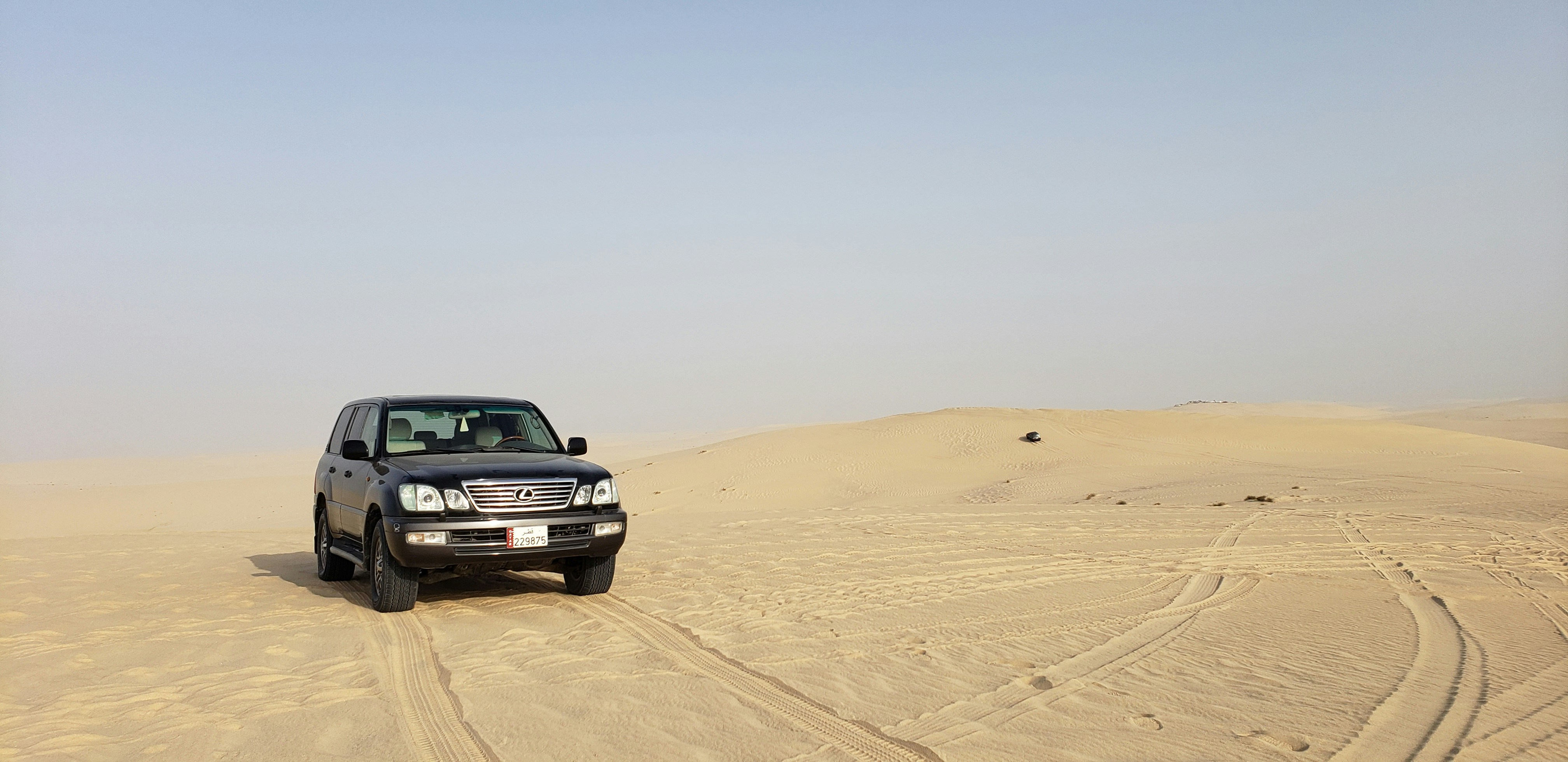 black car on desert during daytime