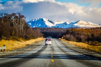 red car on road near mountain range