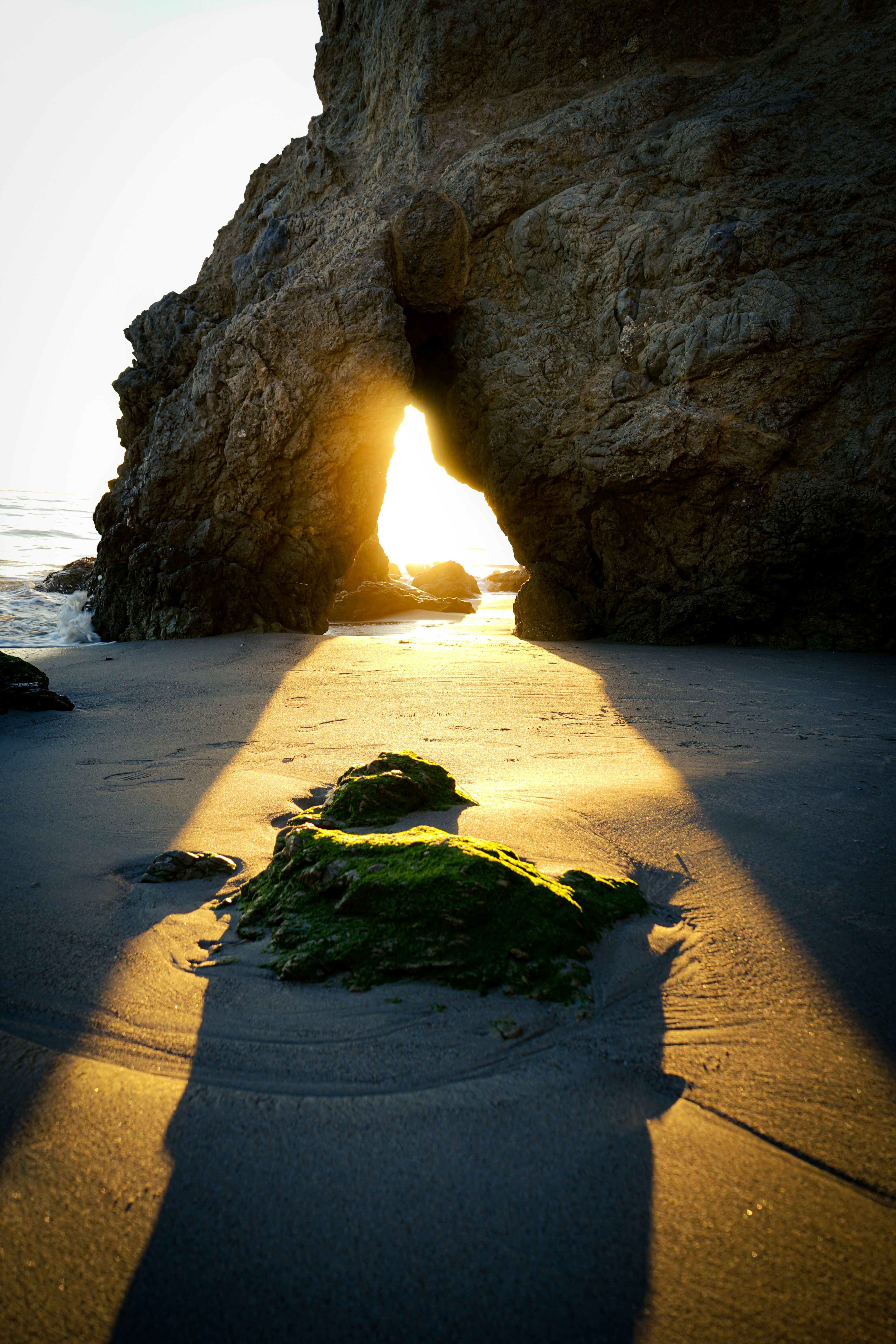 brown rock formation on beach during daytime