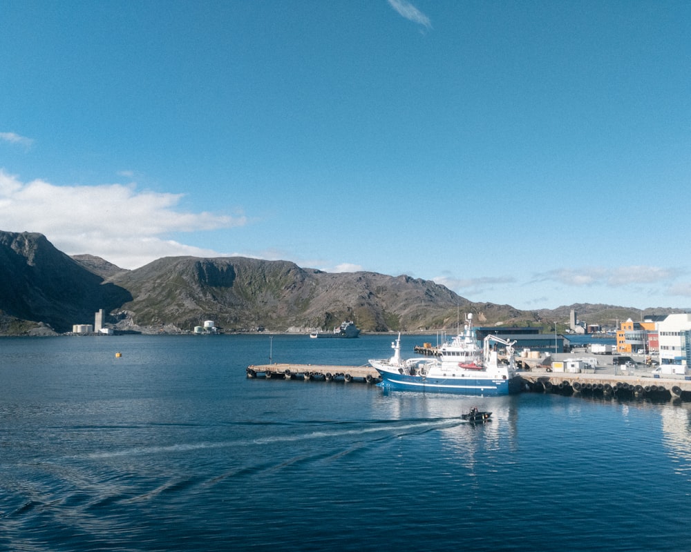 white and blue boat on sea during daytime