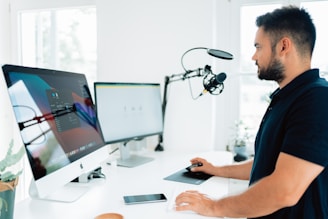 man in blue shirt using computer