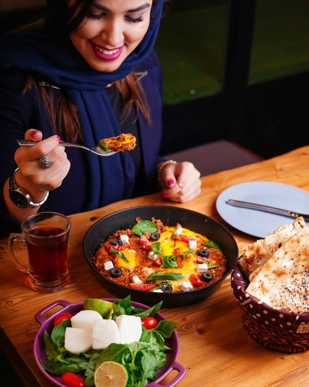 person holding stainless steel fork eating food