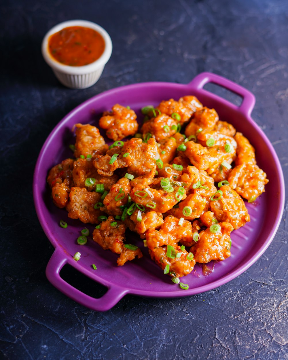 fried food on pink plastic bowl