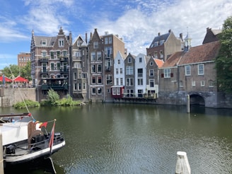 brown and white concrete buildings beside river during daytime