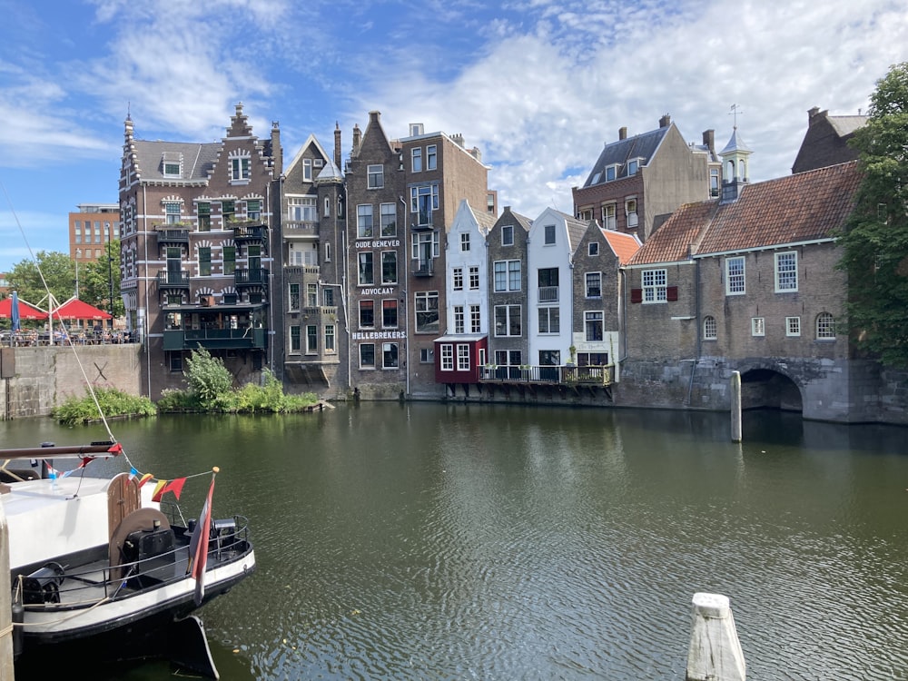 brown and white concrete buildings beside river during daytime