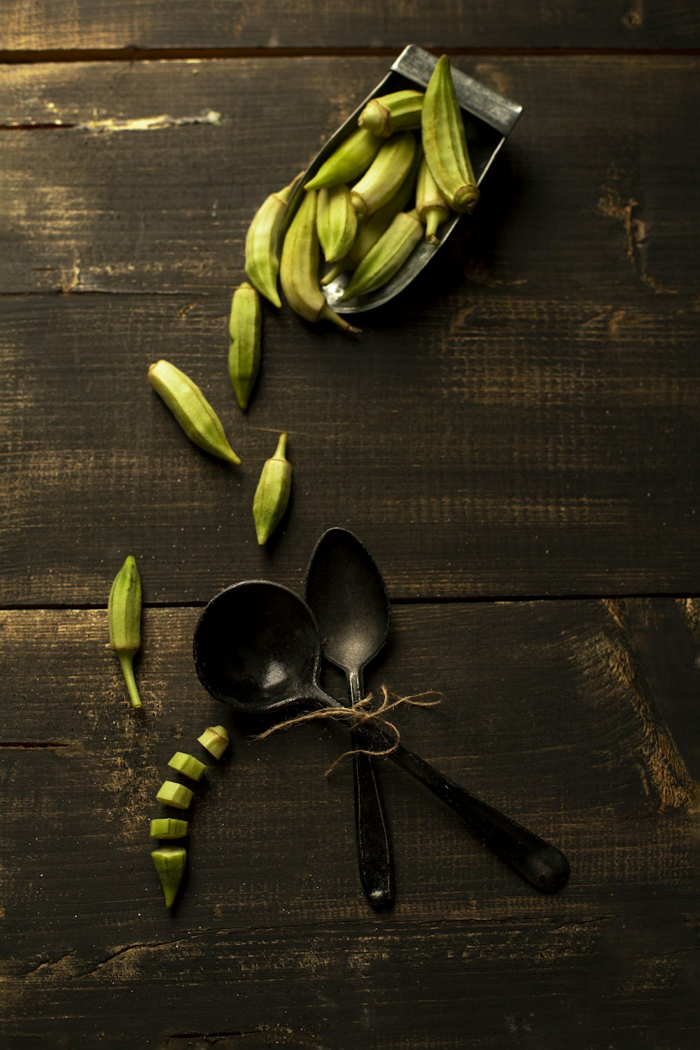 green and black chili on brown wooden table