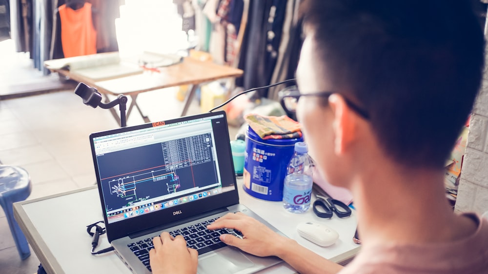 person using black laptop computer