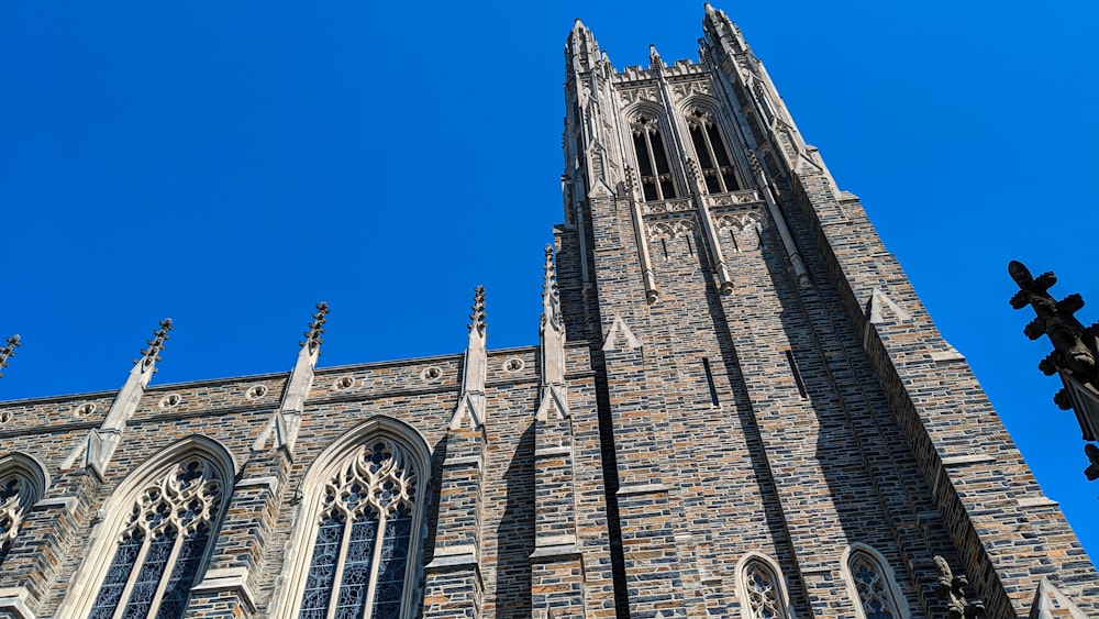 low angle photography of brown concrete building under blue sky during daytime