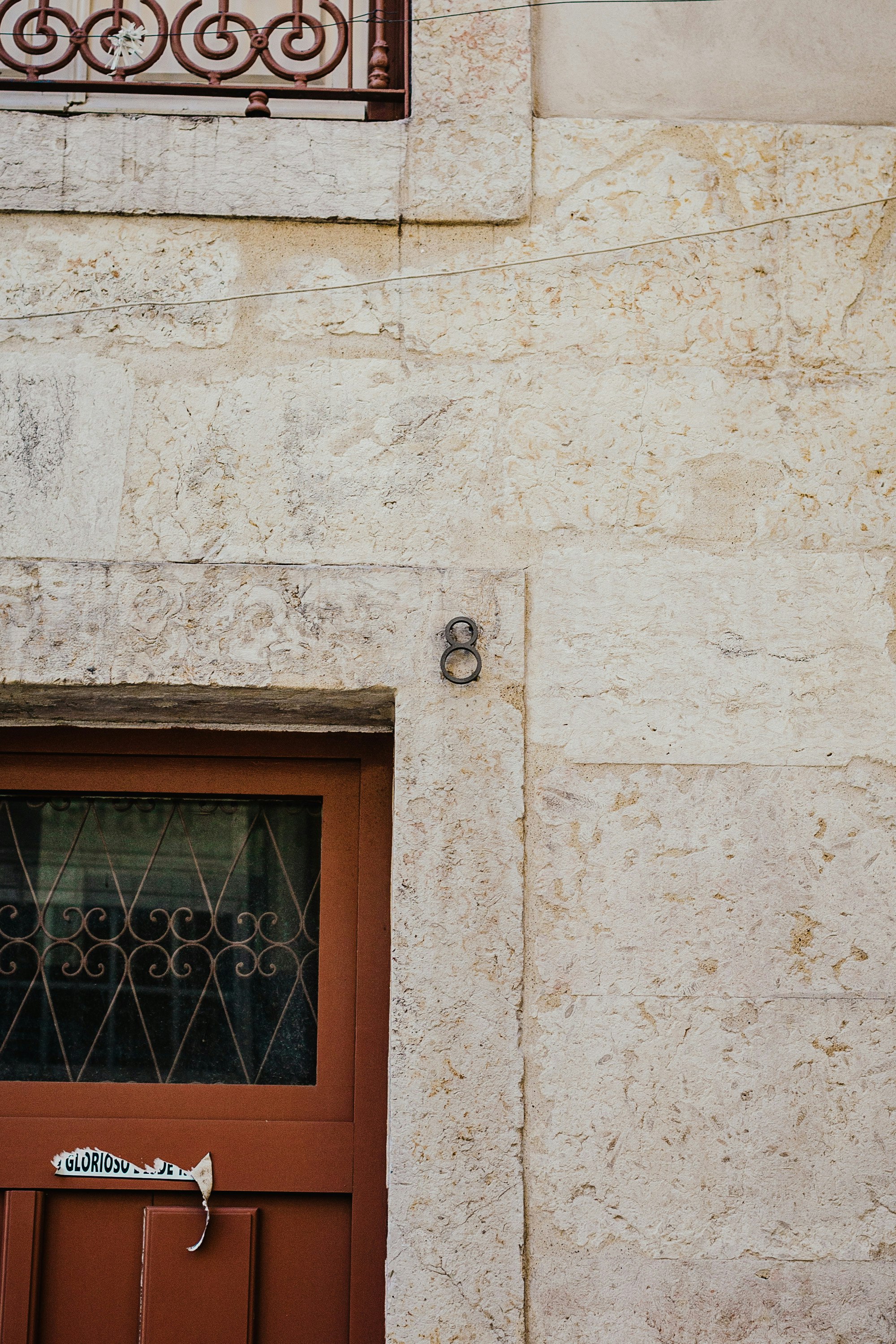 brown wooden window on white concrete wall