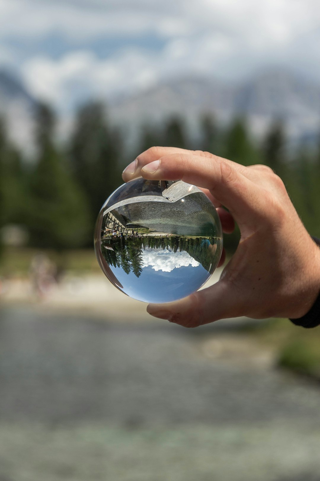 person holding clear glass ball