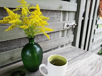 Rustic wooden coffee table with a vase of fresh flowers