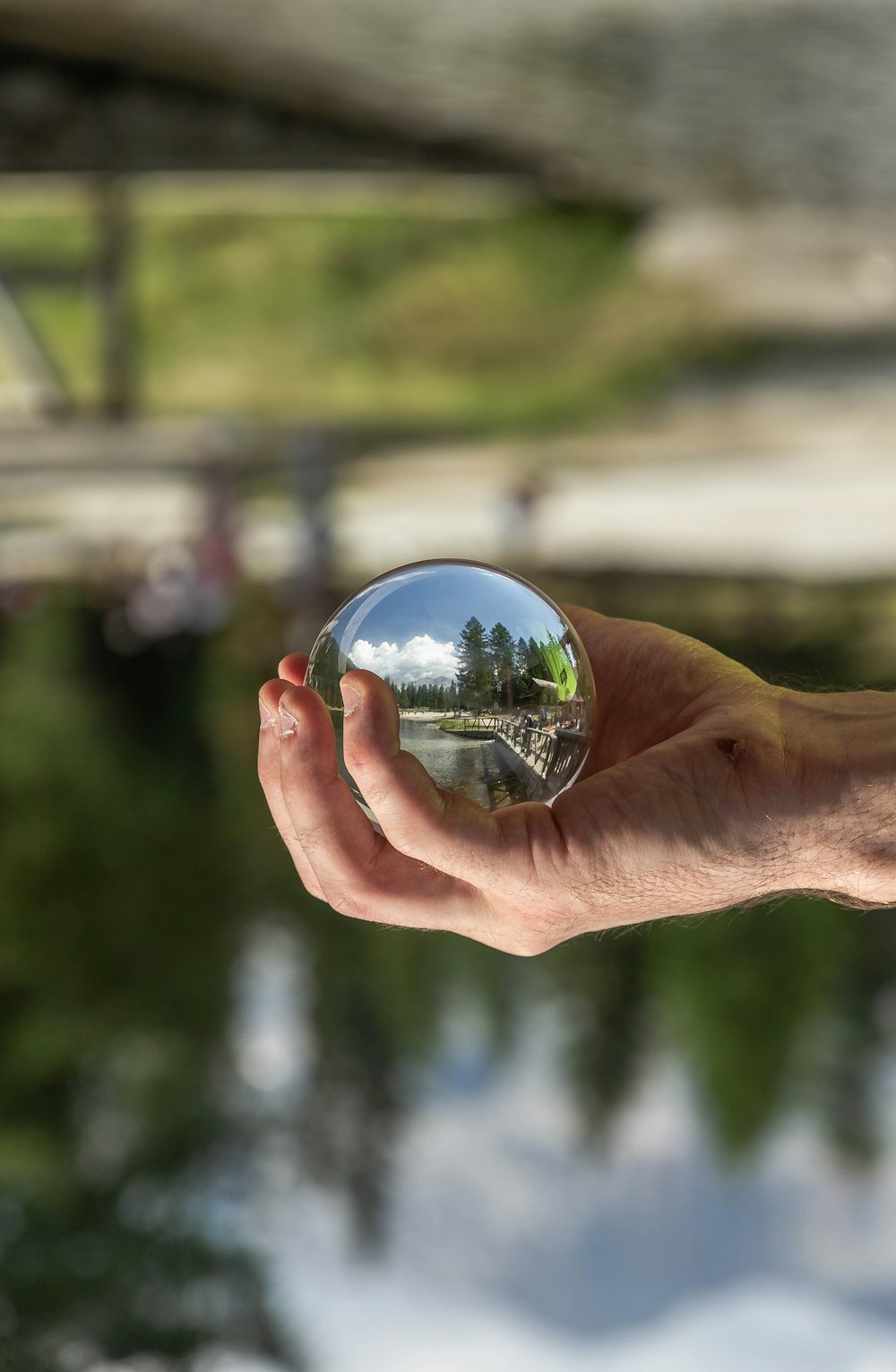 person holding clear glass ball