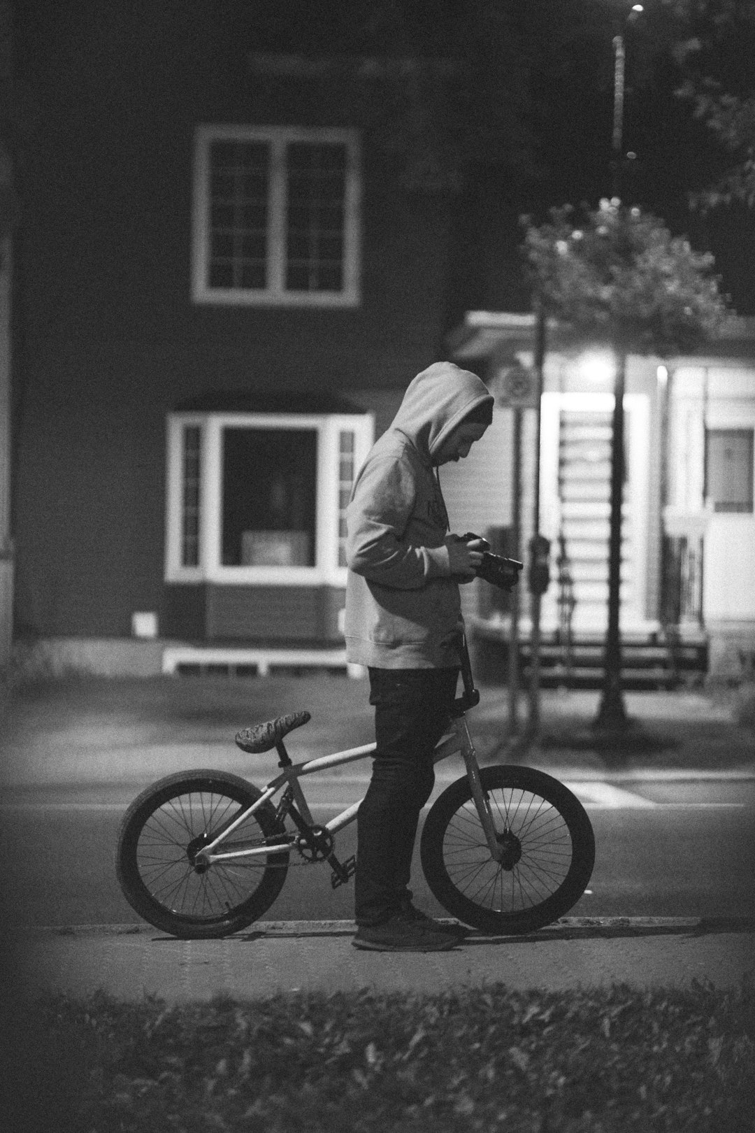 man riding bicycle in grayscale photography
