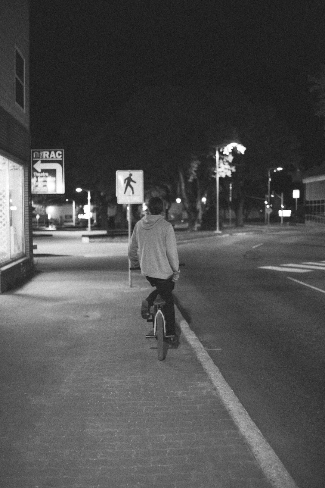 man in black jacket riding bicycle on road