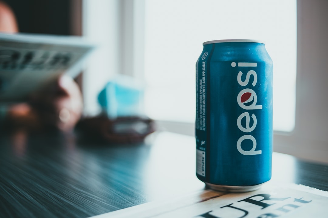 blue pepsi can on brown wooden table