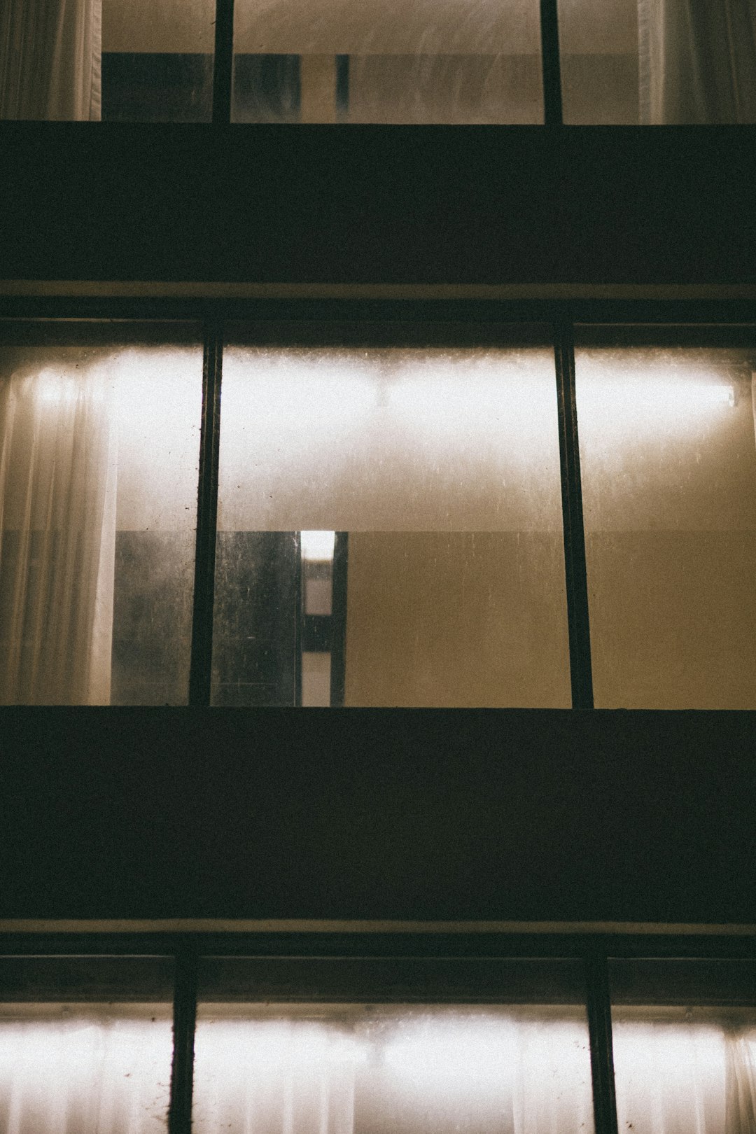 black framed glass window with white window curtain