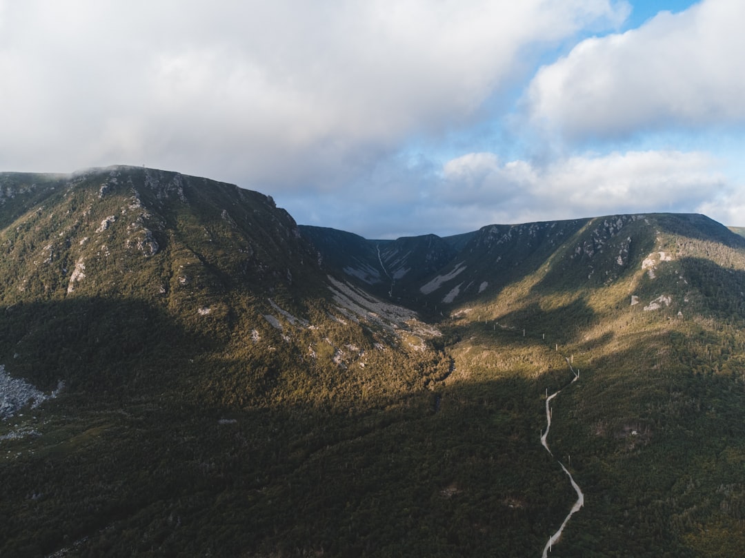 green and brown mountains under white clouds during daytime