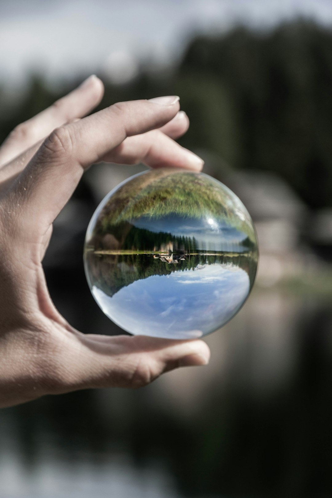 person holding clear glass ball