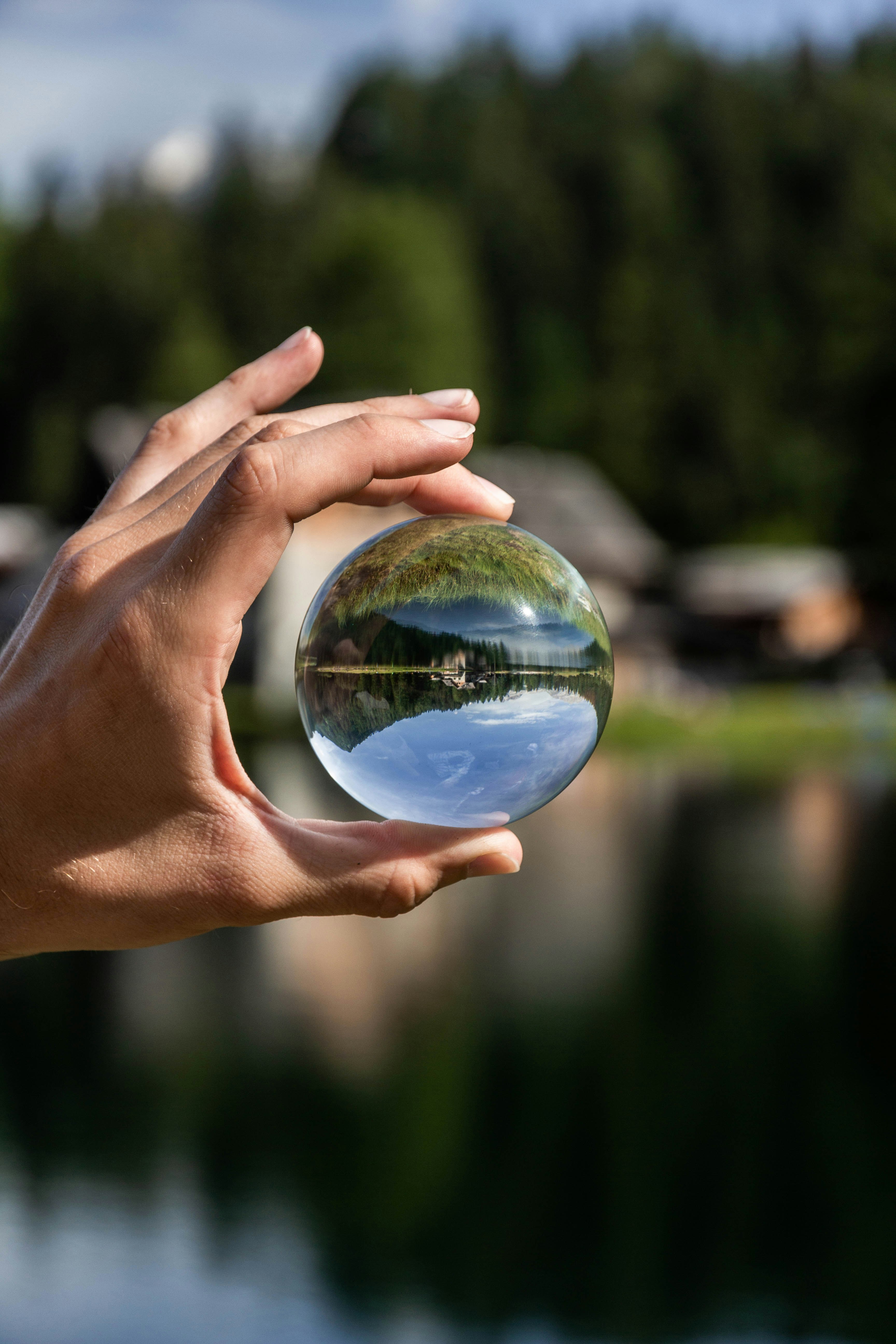 person holding clear glass ball