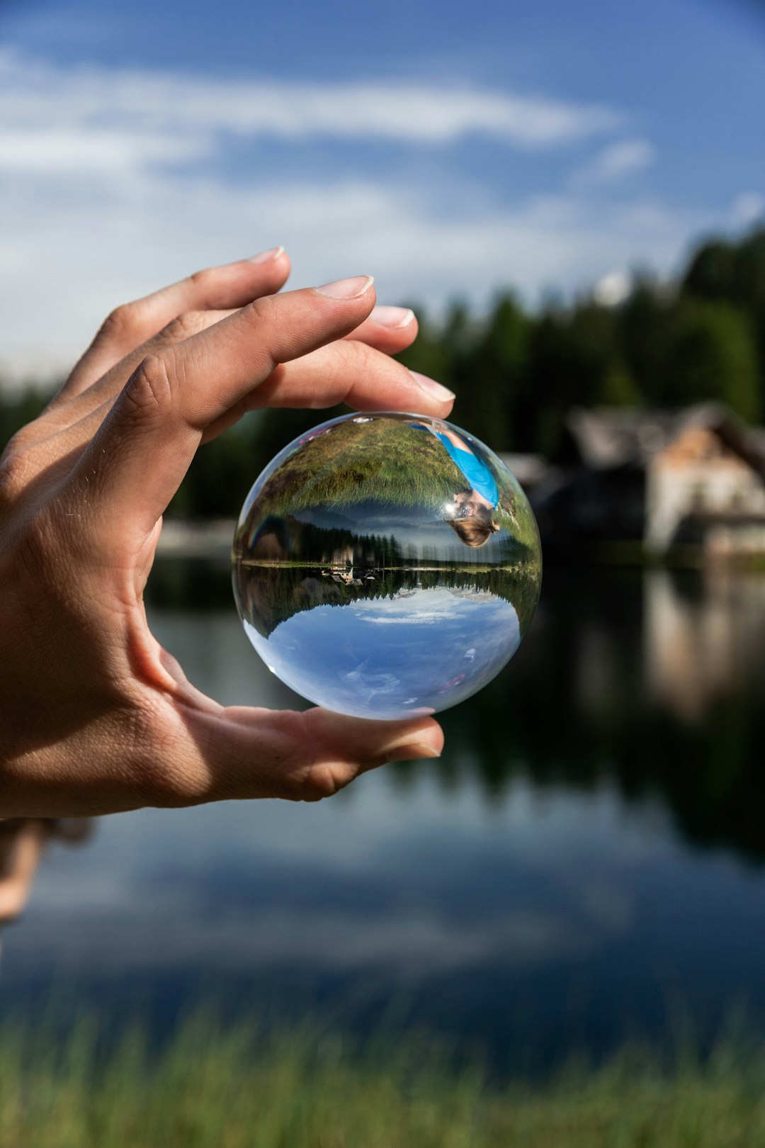 person holding clear glass ball