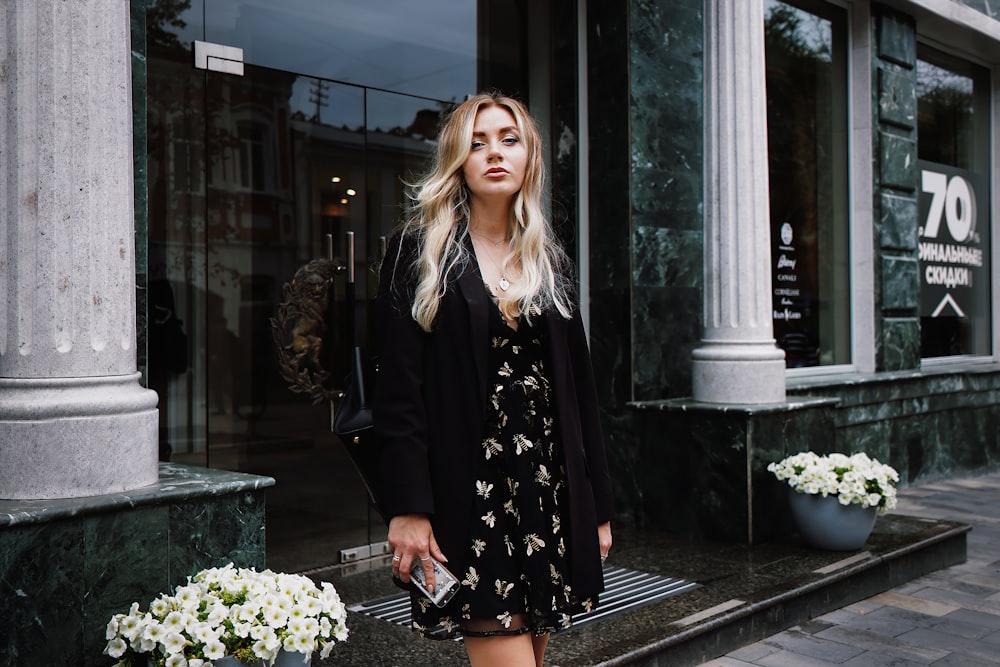 woman in black coat sitting on black bench