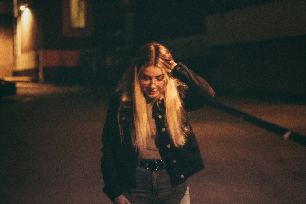 woman in black jacket and gray denim jeans