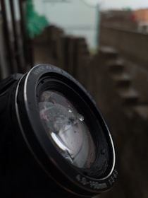 Macro shot of a lens surface showing water droplets repelled by coating.