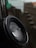 Close-up of flood sensor device mounted on a wall with water droplets nearby.