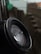 Close-up of flood sensor device mounted on a wall with water droplets nearby.