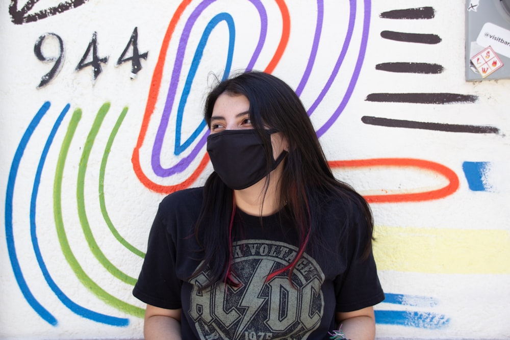 woman in black crew neck t-shirt wearing black mask