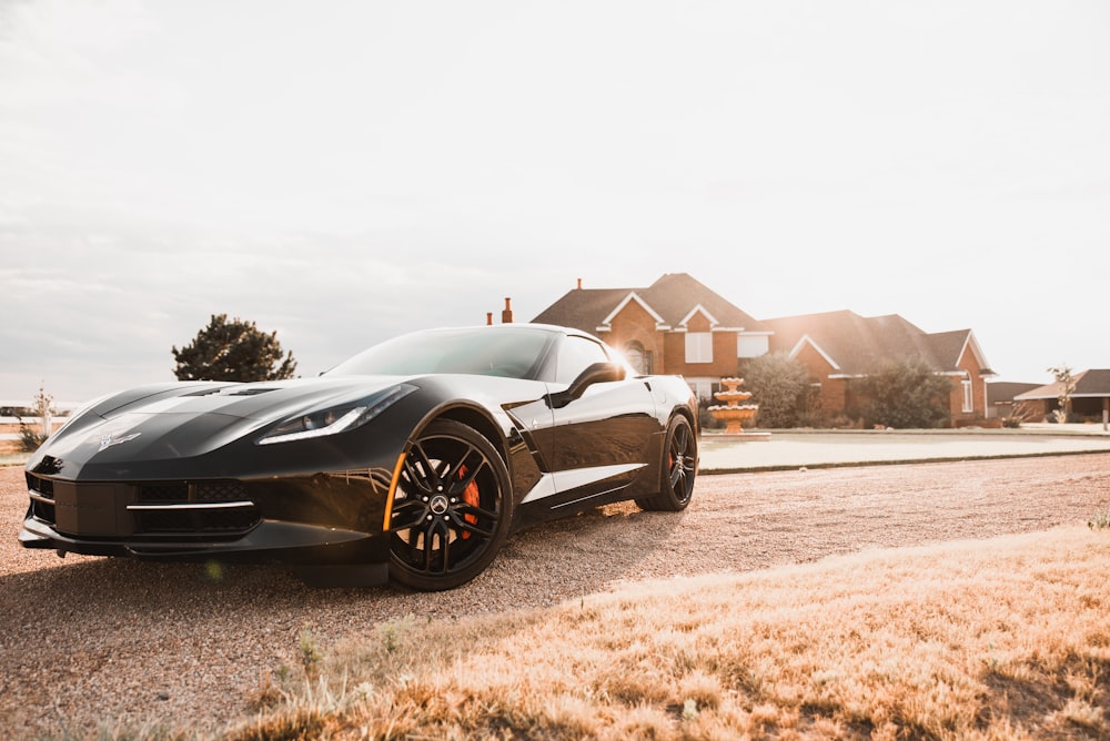 black coupe on brown field during daytime