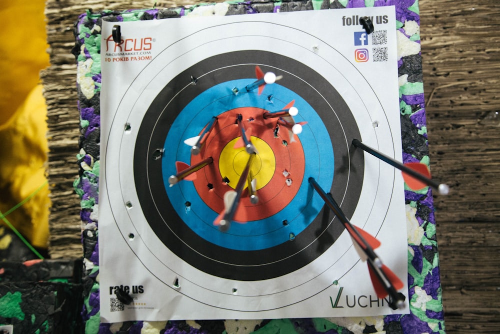 a close up of a target with arrows in it