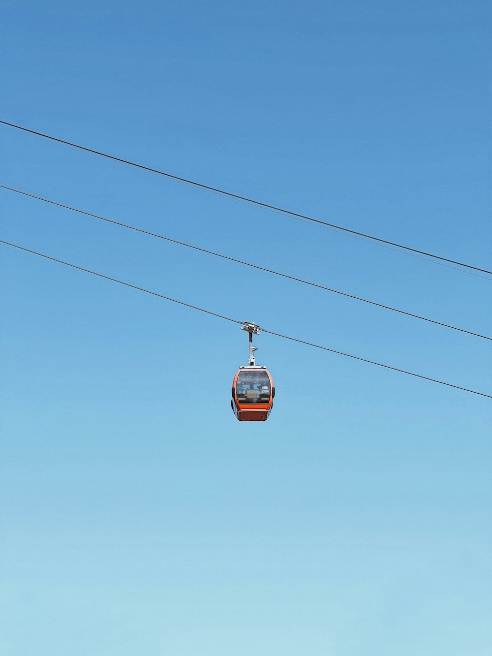 red cable car under blue sky during daytime