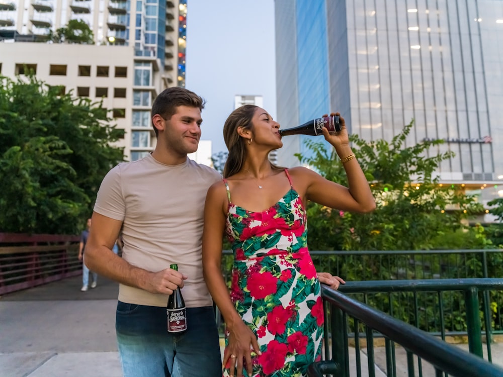 man and woman standing beside railings during daytime