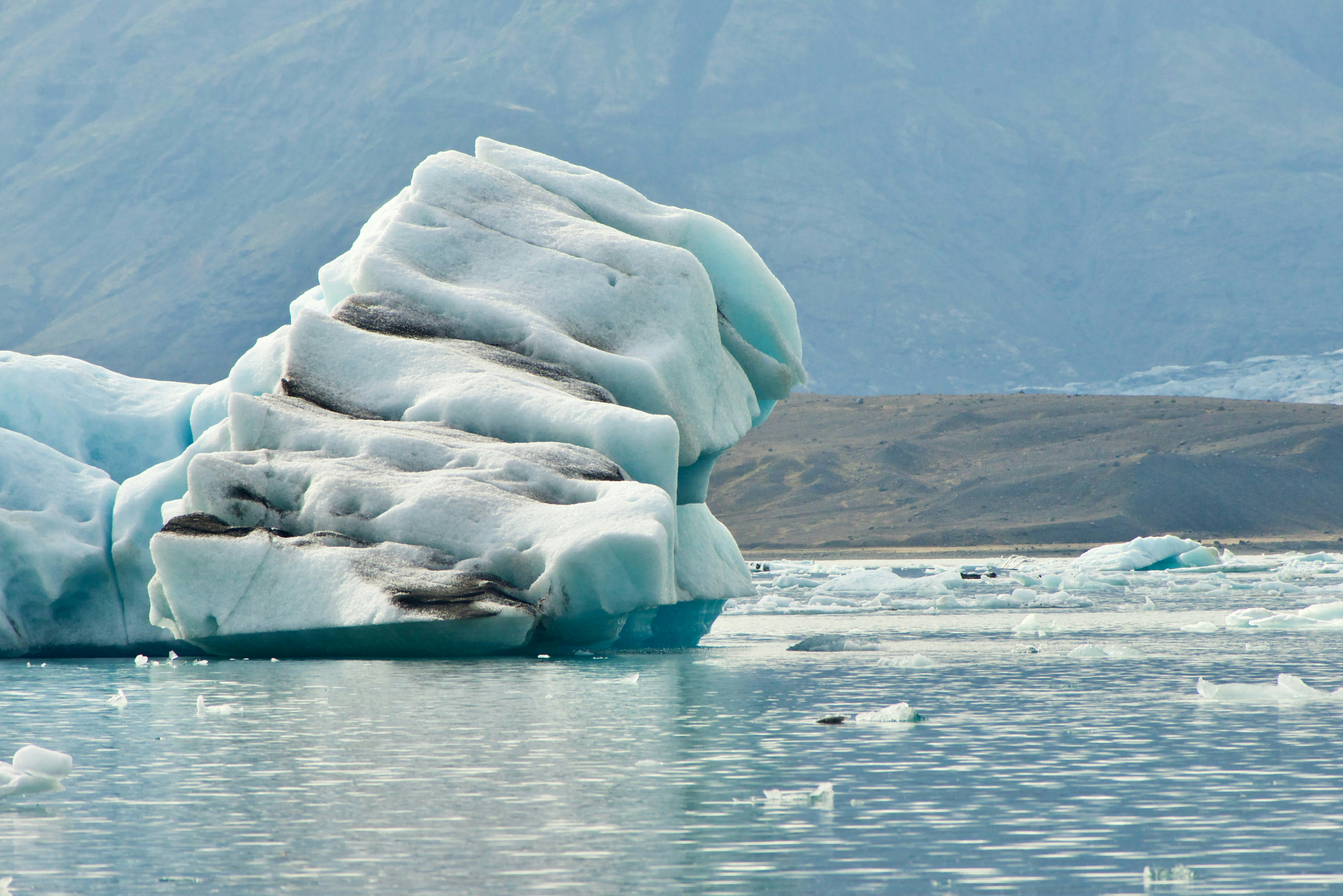 white ice formation on body of water during daytime