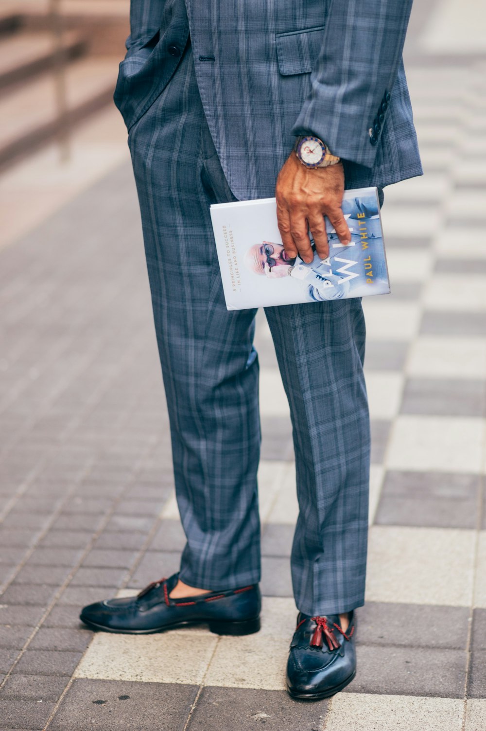 man in blue denim jacket and blue denim jeans holding white paper