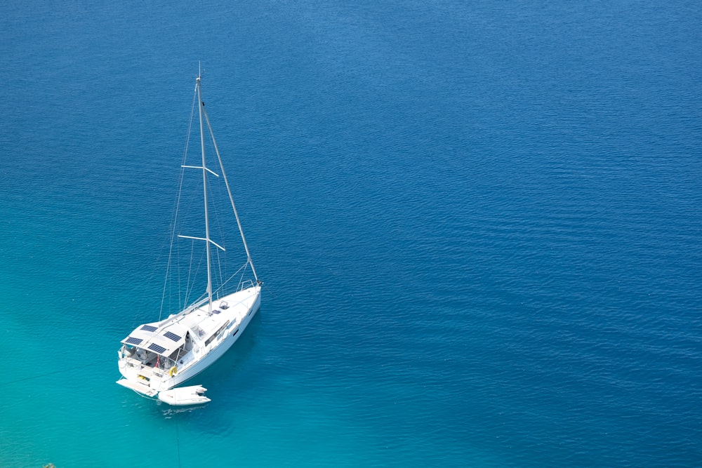 white and black boat on blue sea during daytime