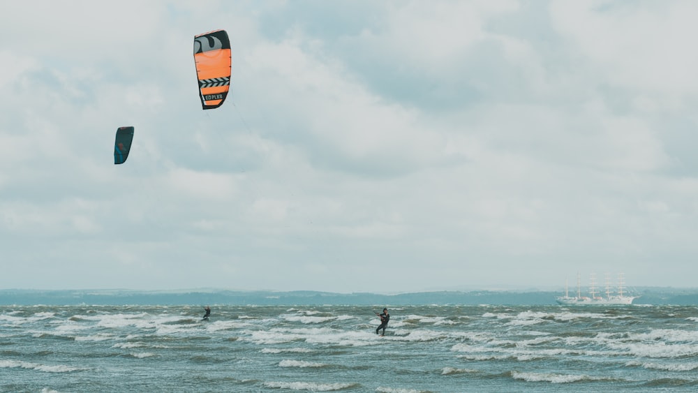 person surfing on sea under cloudy sky during daytime