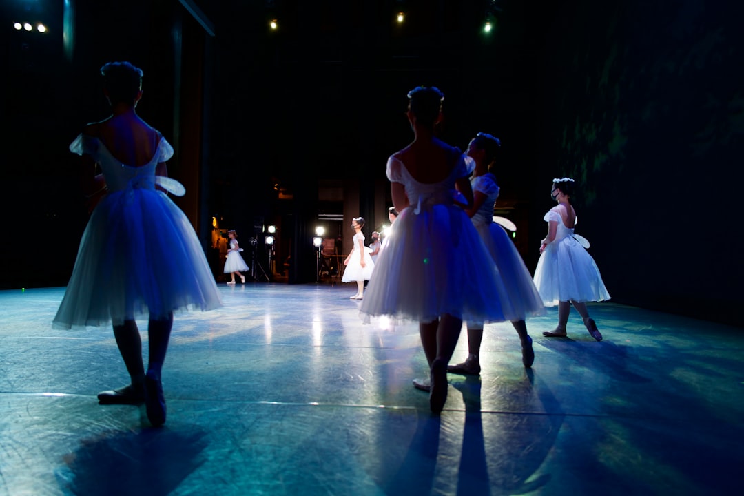 woman in white dress dancing on ice field during night time