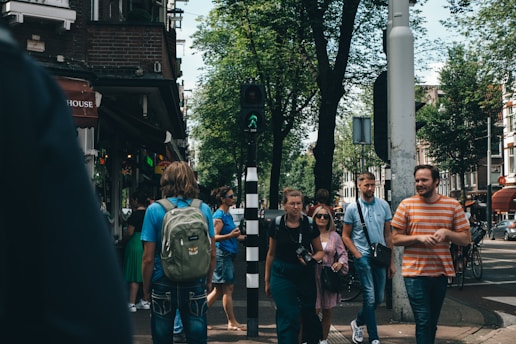 Happy tourists exploring a vibrant city street with local guides.