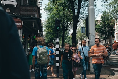 A group of students exploring a vibrant city street overseas, smiling and chatting.