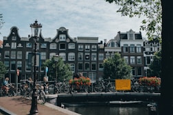 people walking on sidewalk near brown concrete building during daytime
