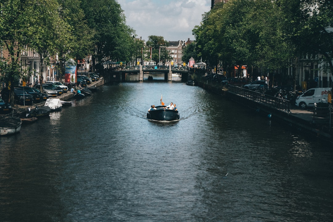 people riding on boat on river during daytime