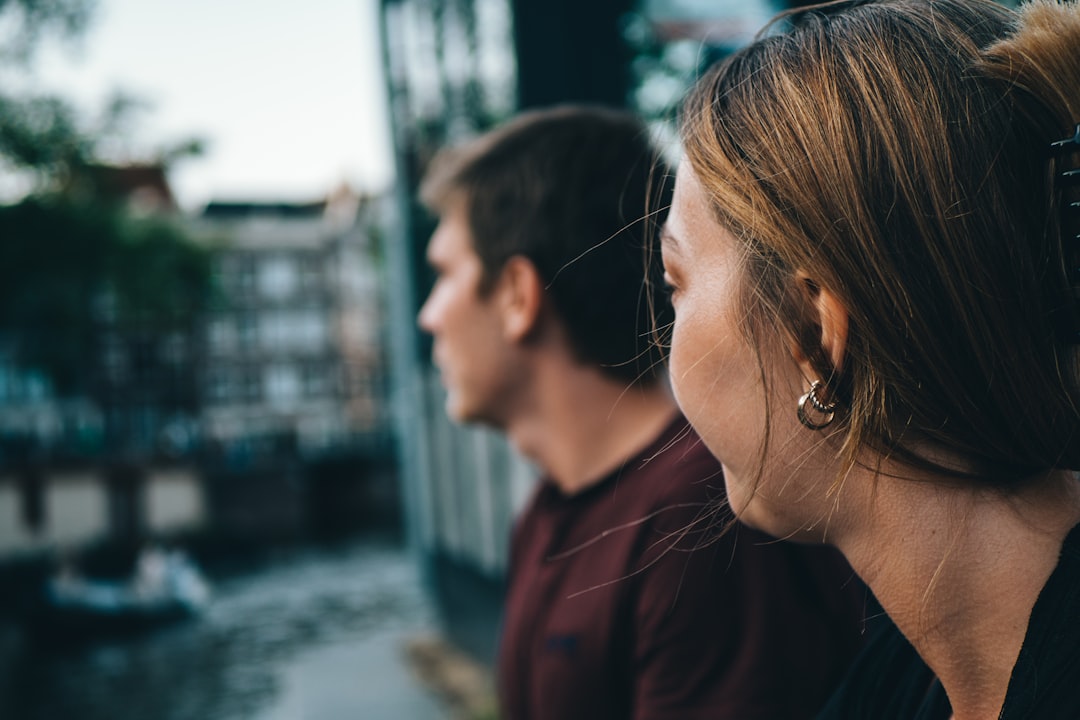 man and woman kissing during daytime