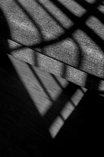 Shadow play on textured fabrics, suggesting sinnliche Geometrie.